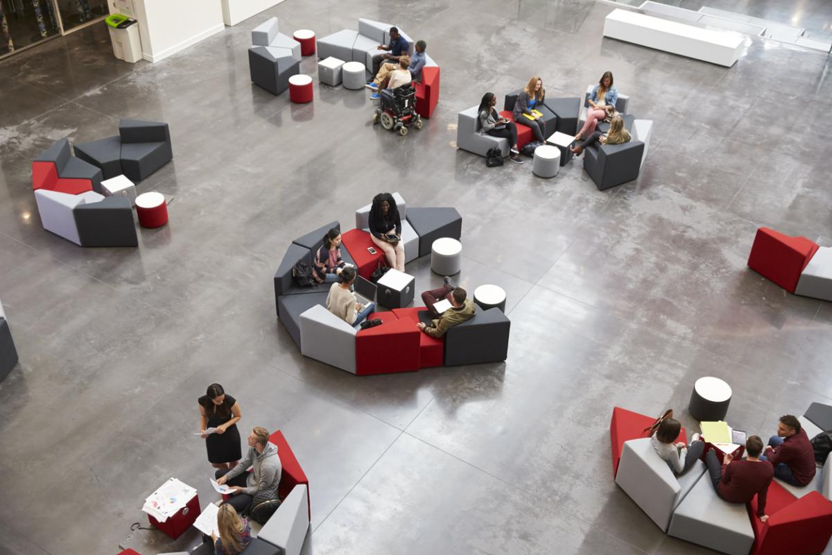 Attendees sit in groups on modular furniture